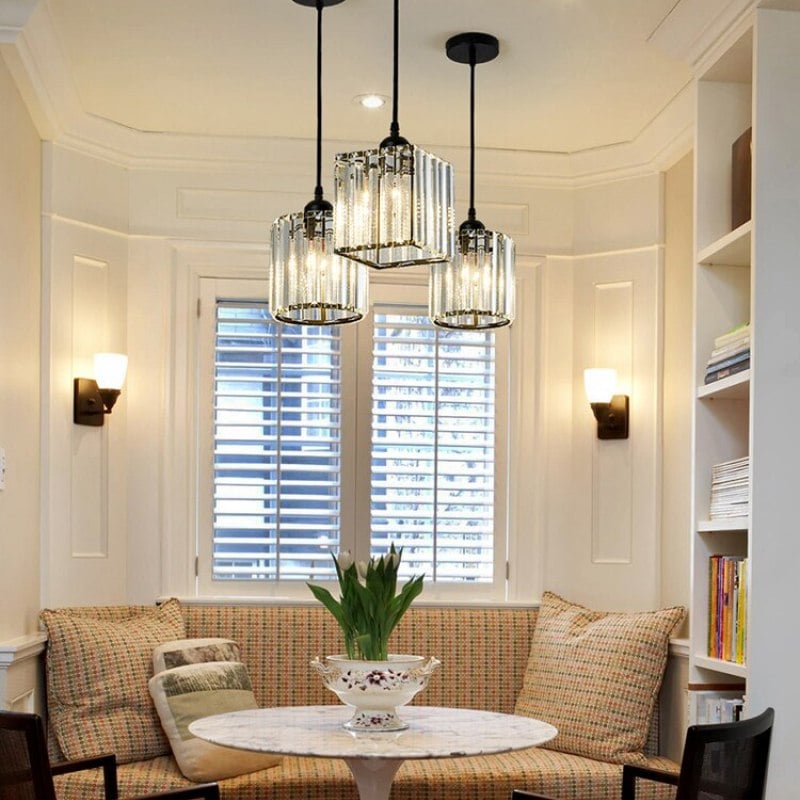 Mixed round and square separately hung black glass pendants above breakfast nook with bench, blinds and wall sconces