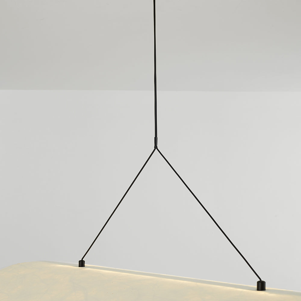 Detail of the black suspension line branching into two arms attached to the curled shade
