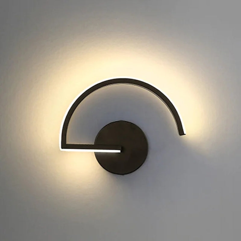 Illuminated black arc wall lamp creating a curved glow on the wall.