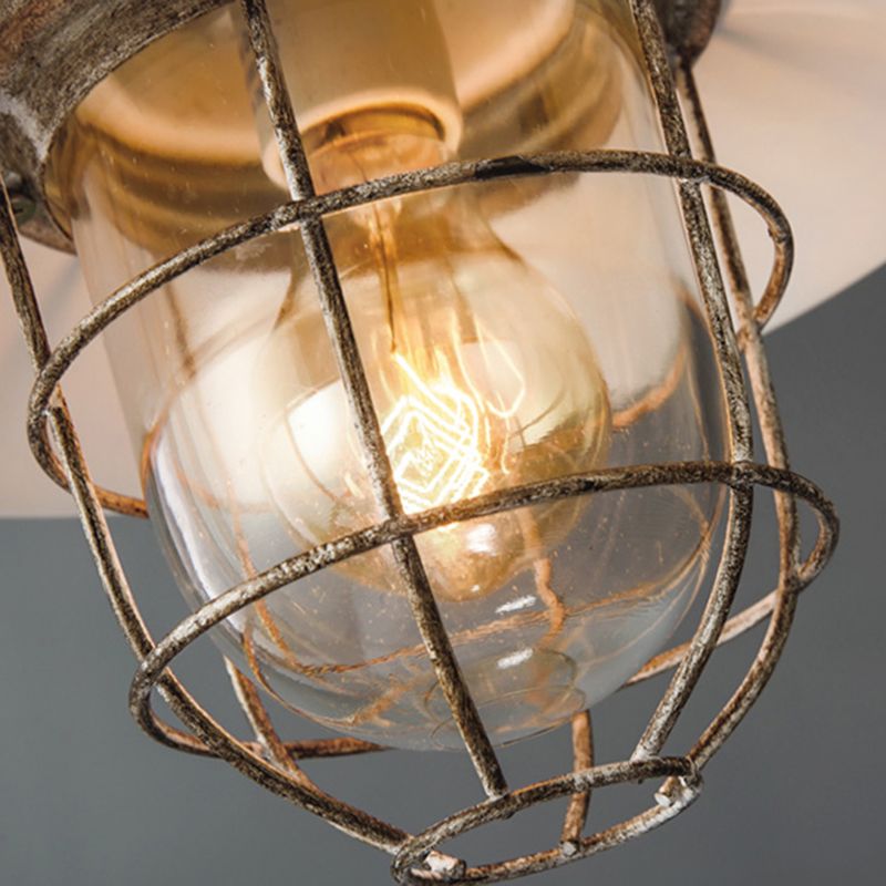 Close view of bulb behind Alessio glass enclosure and metal cage