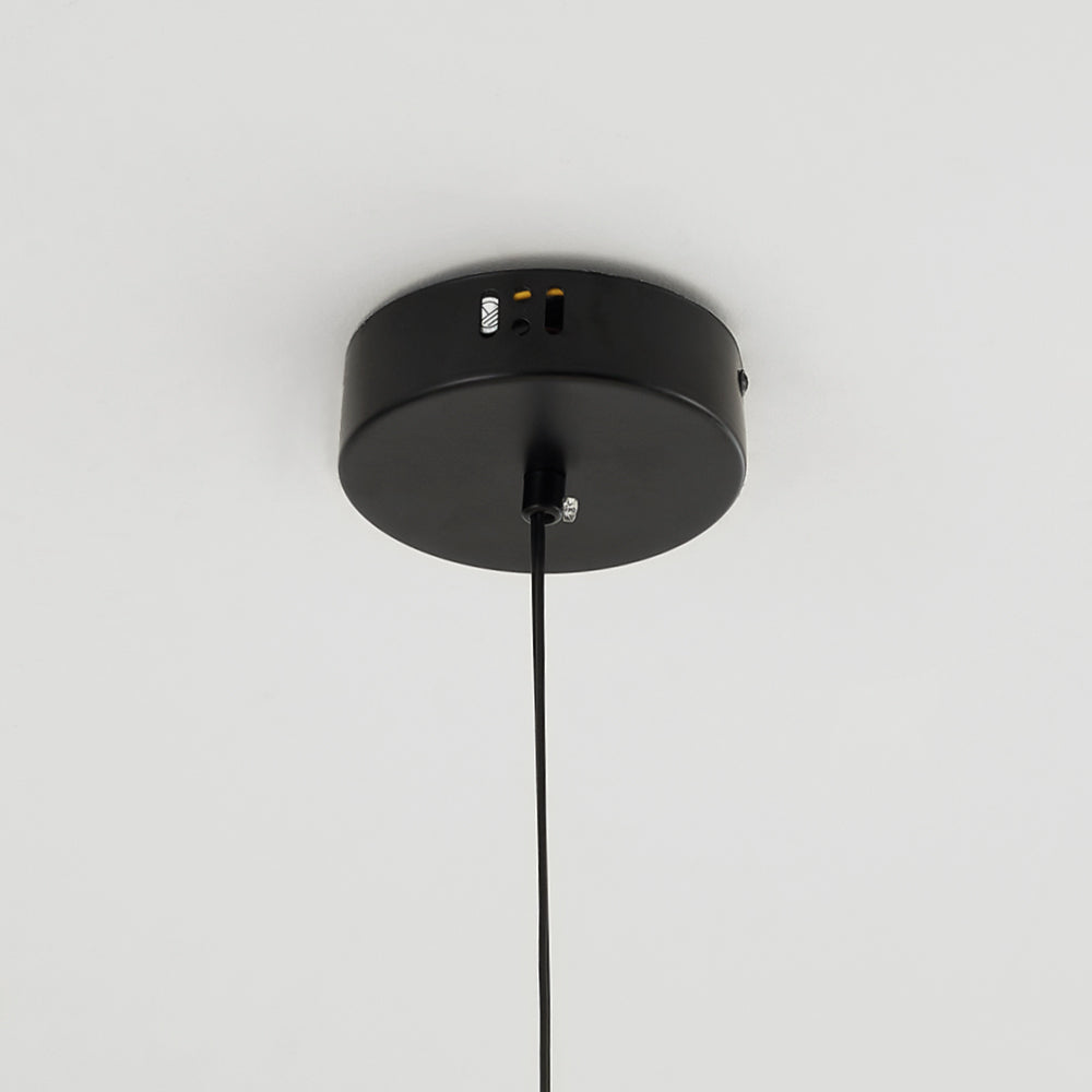 Close-up of the round black canopy, cable entry, small side openings and a side fastener