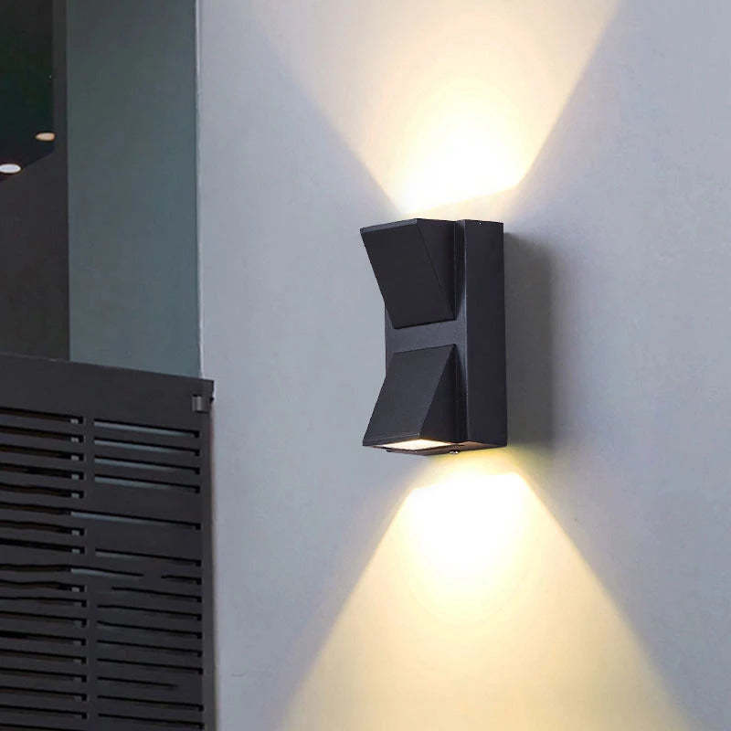 Black Orr two-head exterior wall light casting beams up and down