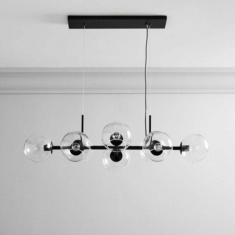 Unlit black Valentina clear-globe pendant beneath a rectangular black canopy with suspension lines and power cable