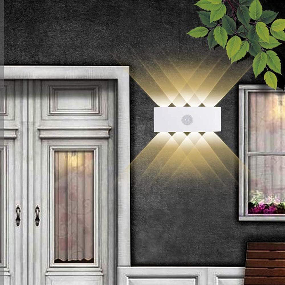 White curved wall light casting four beams upward and four downward beside an exterior door