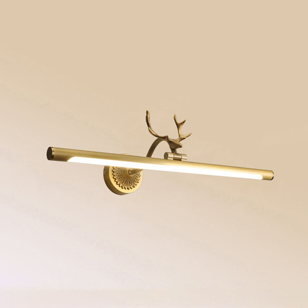 Brass-coloured antler light isolated against a beige wall