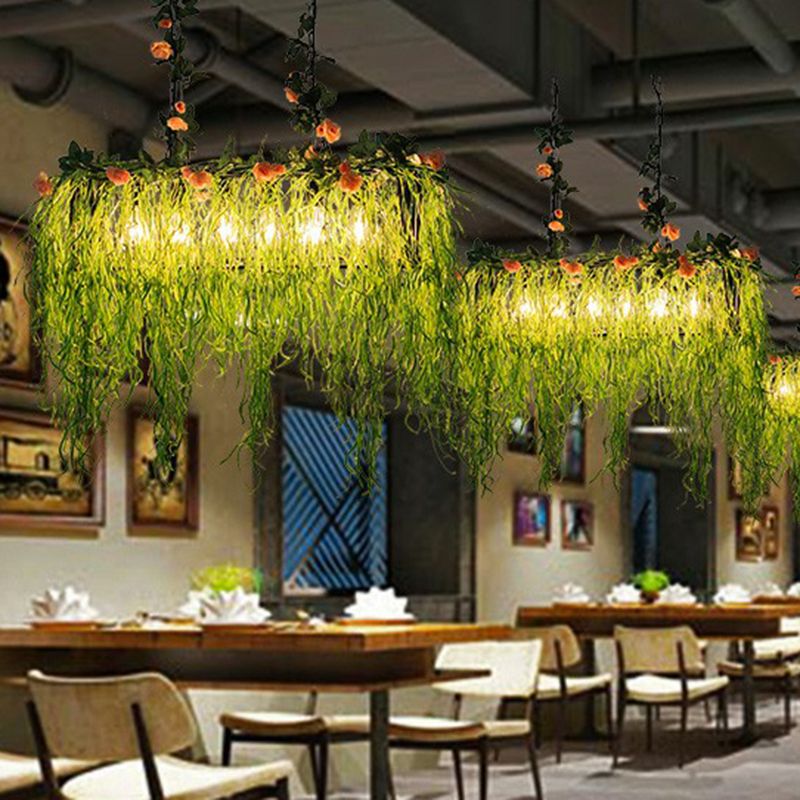 Green trailing-foliage pendants above restaurant tables