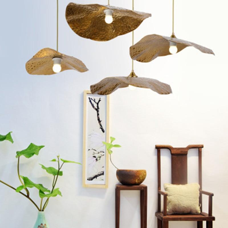 Three textured leaf pendants beside chair and plant