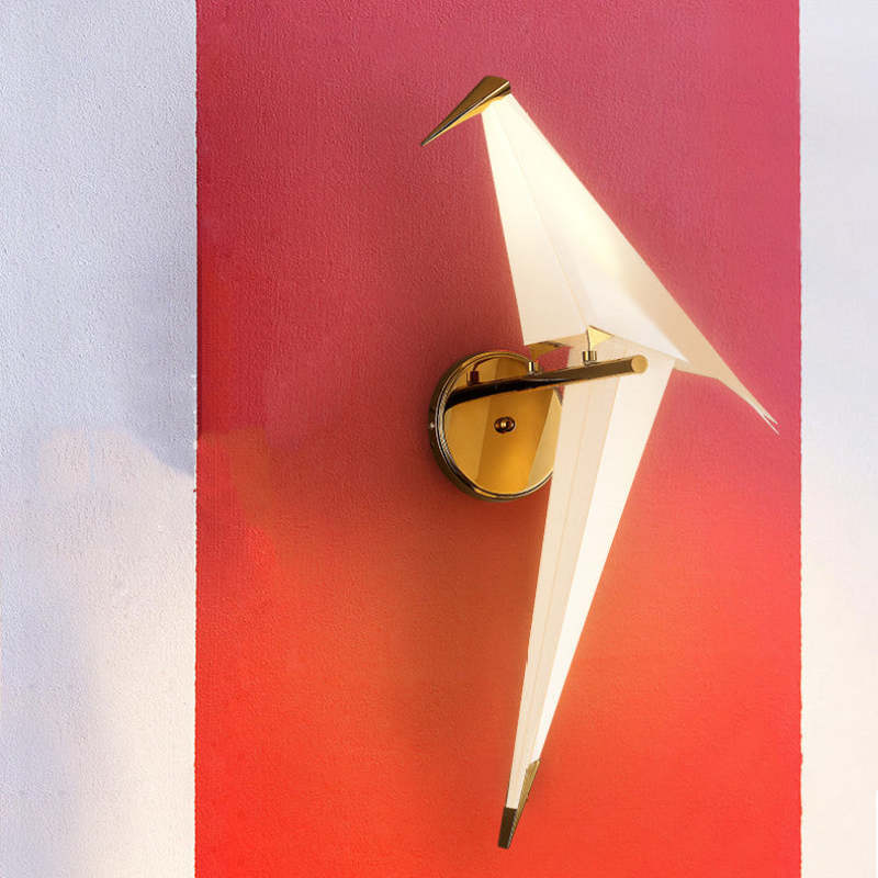 White angular Clifford bird with a gold-tone beak and long tail illuminated against a red-and-white wall