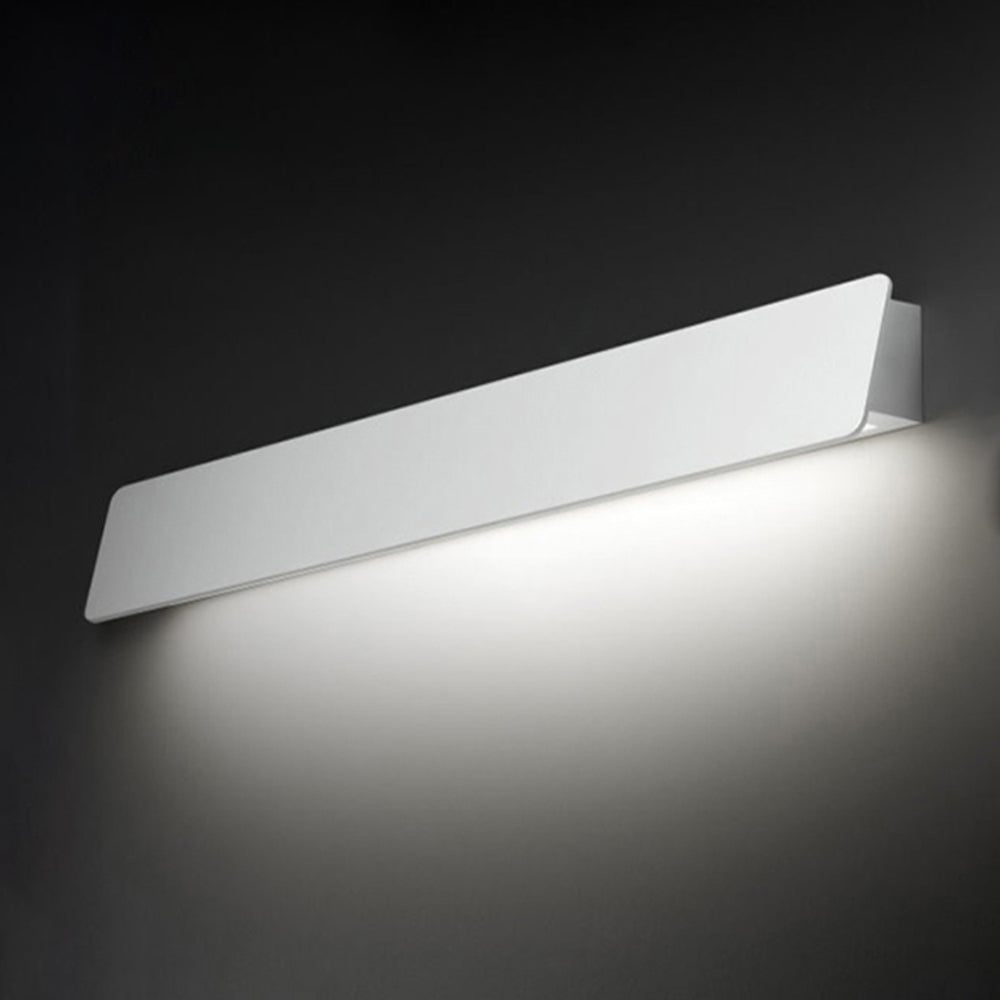 White Orr wall light with downward illumination against a dark wall