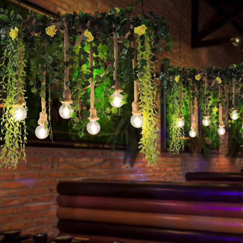 Two Nest greenery pendants above restaurant booth seating