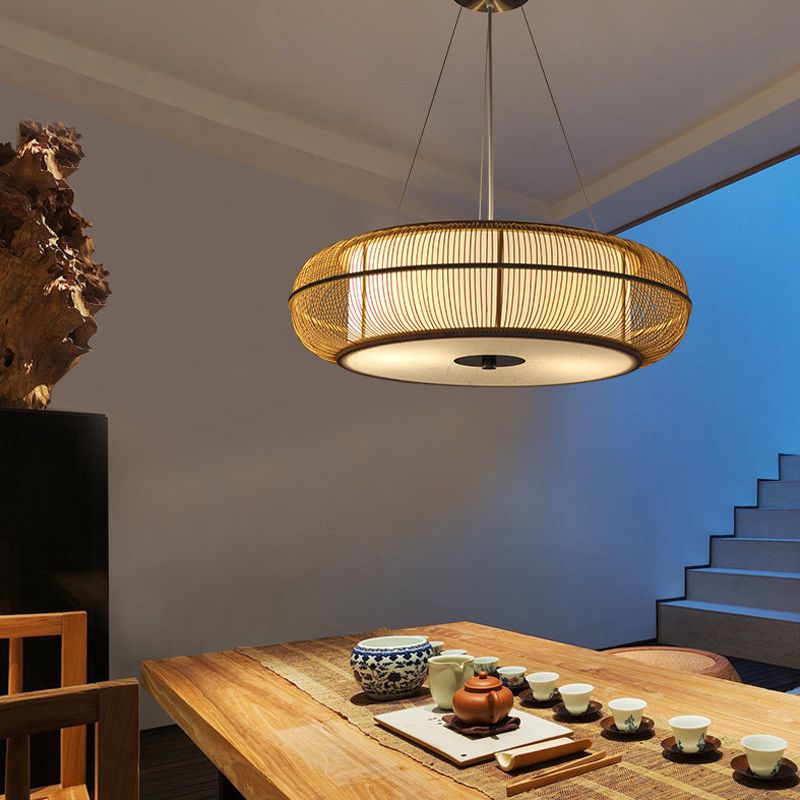 Wood Ozawa pendant above a dining table with tea cups.