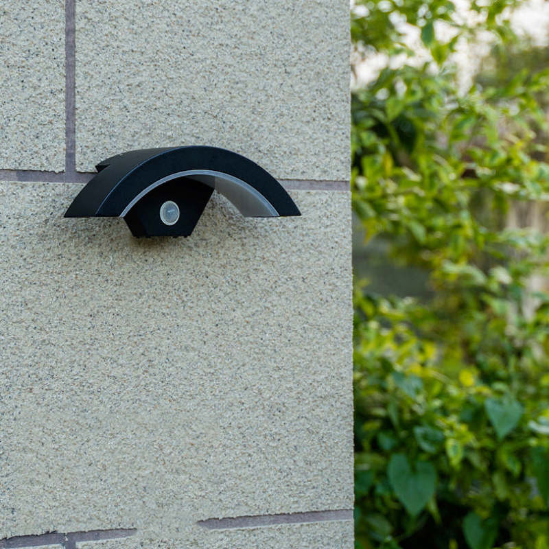 Unlit sensor wall lamp on an exterior pillar