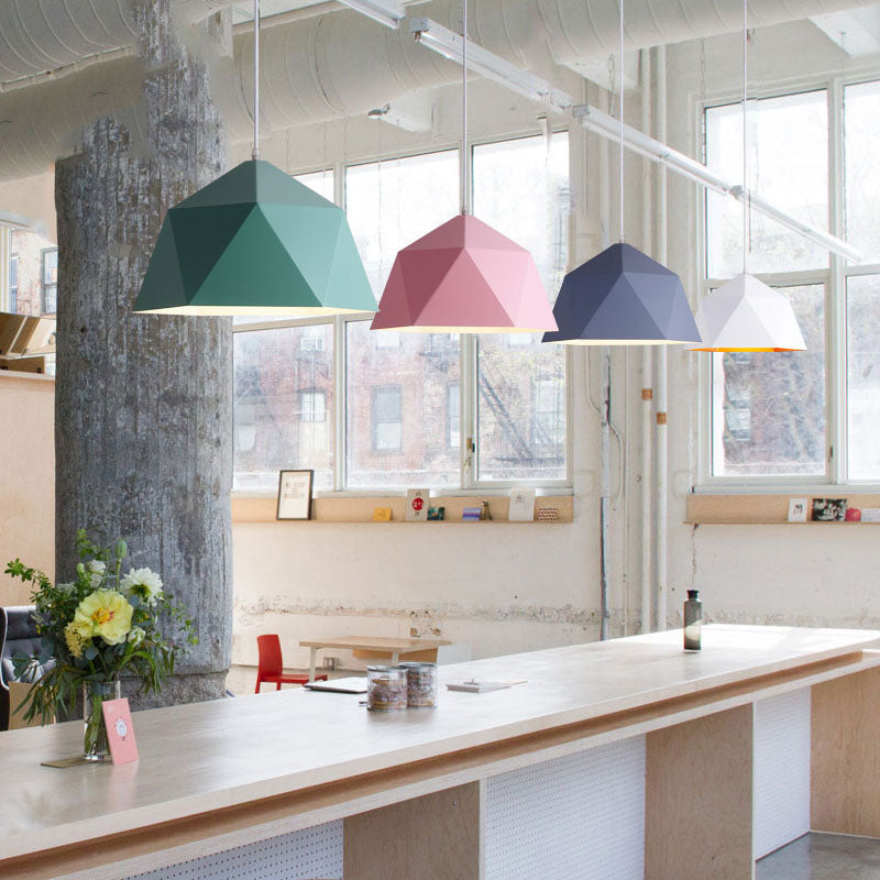 Green, pink, blue-toned and white faceted pendants along a bright interior counter