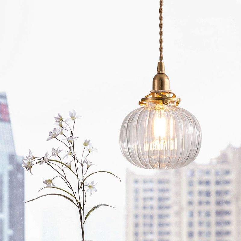 Clear glass pendant near a window and flowering branch