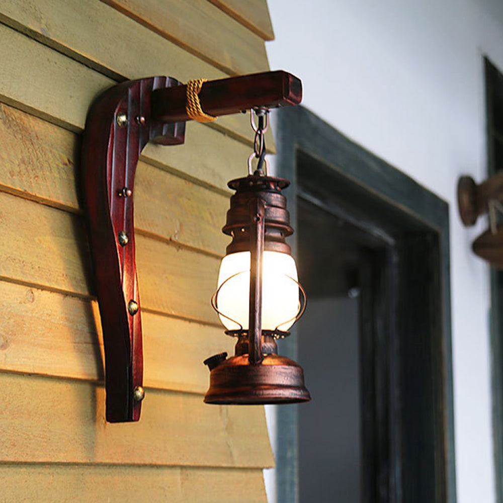 Illuminated Austin wall lantern on a horizontal timber-clad wall.