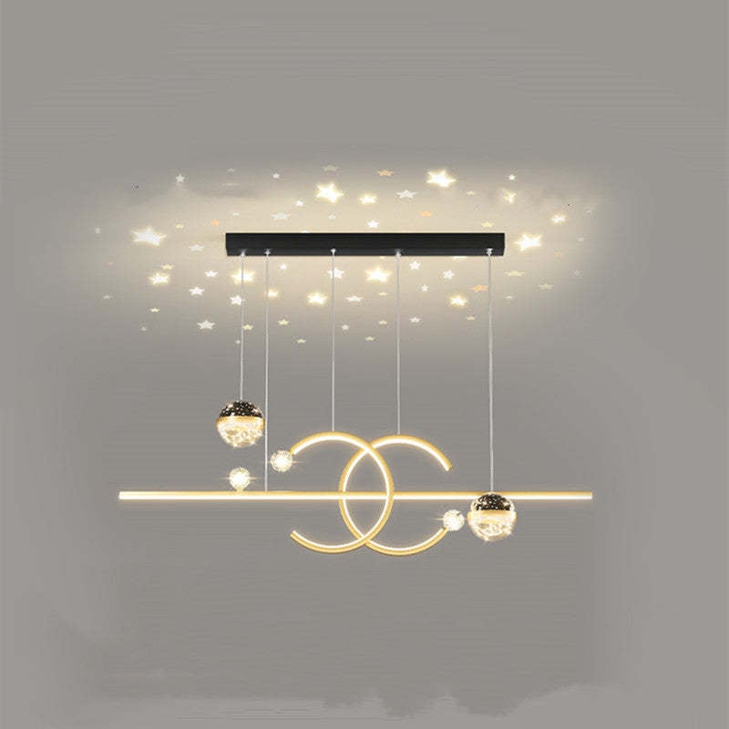 Gold Madina double-C and globe pendant with star-shaped ceiling illumination