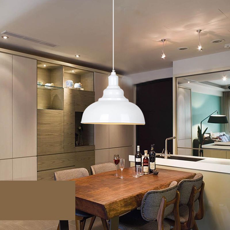 White Cooley dome pendant with a stepped neck above a wooden dining table with wine bottles