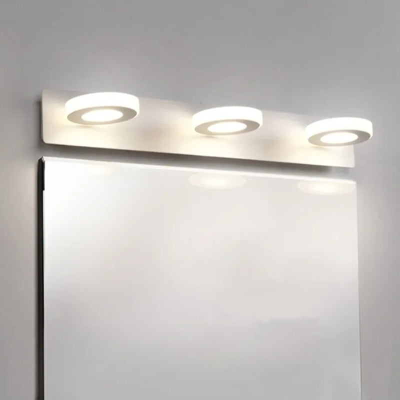 Three-disc Leigh vanity light above a rectangular mirror