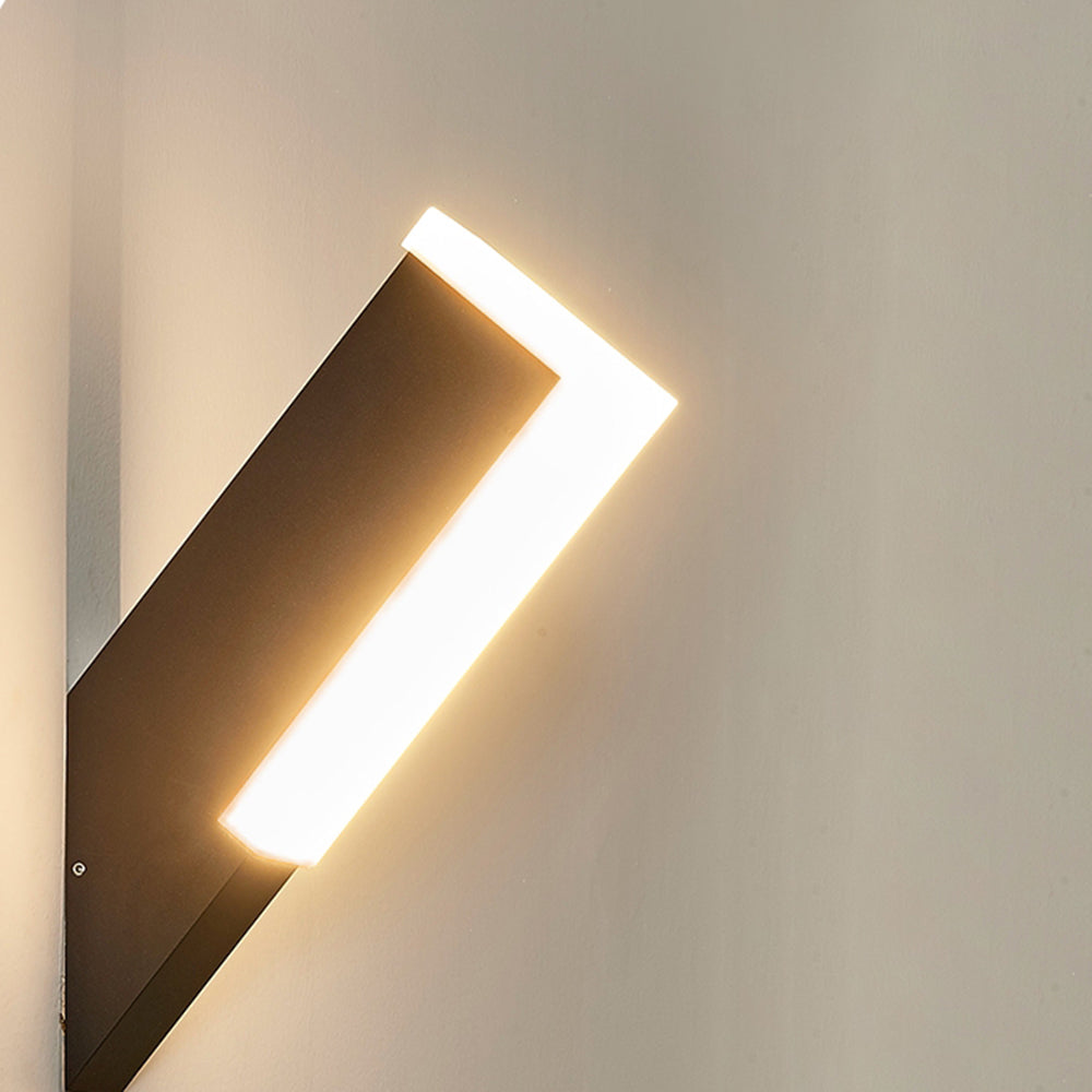 Close view of angled black Orr wall fixture with white lit edge