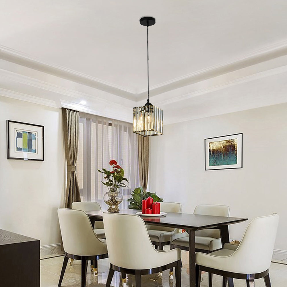 Single black Herbert square glass pendant above a dining table with white chairs, flowers and red candles