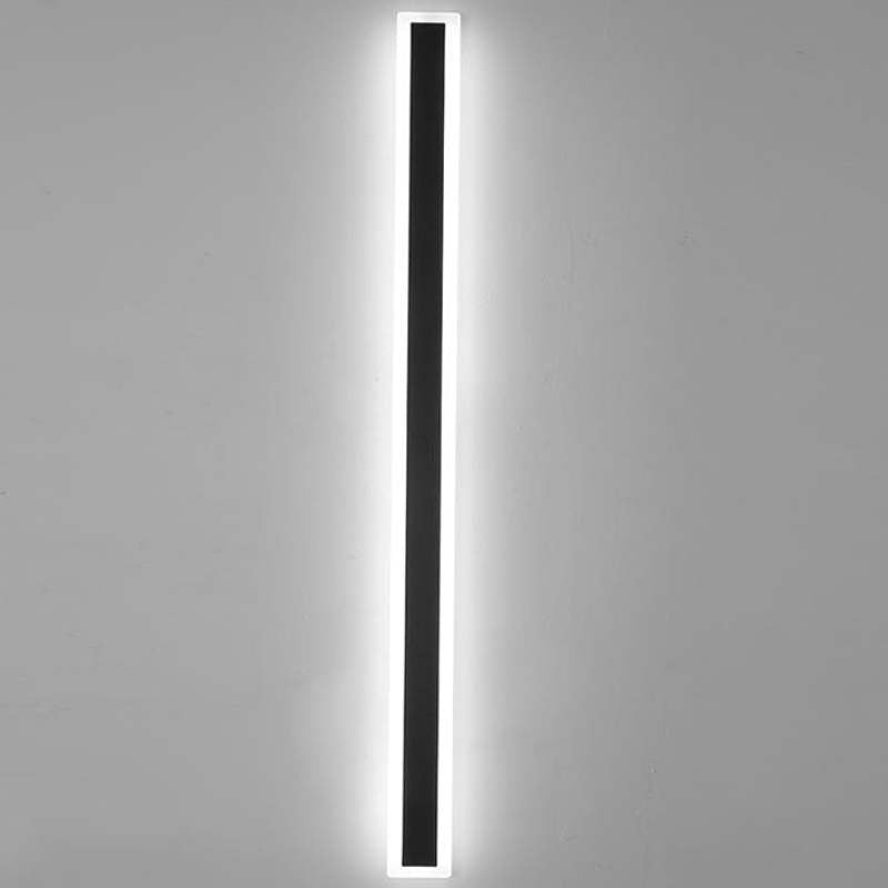 Front view of an illuminated Edge wall light with a dark center and pale border