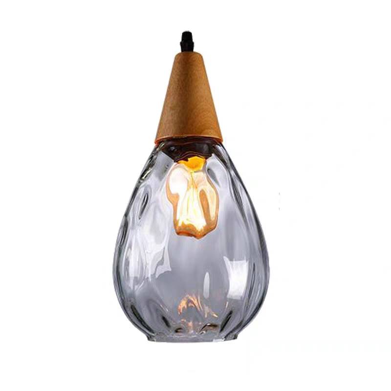 Close isolated clear Avi teardrop glass shade with rounded texture, tapered wooden top and visible lit bulb