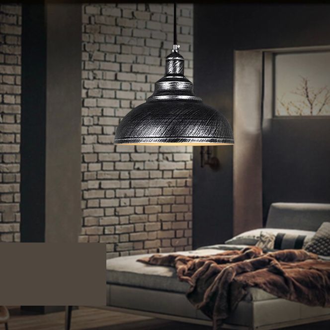 Silver Gray distressed dome pendant near a sofa against a dark brick wall