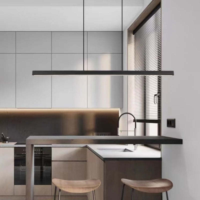Black Edge light bar above dark stone kitchen island with sink, tall tap, wooden stools and window blinds