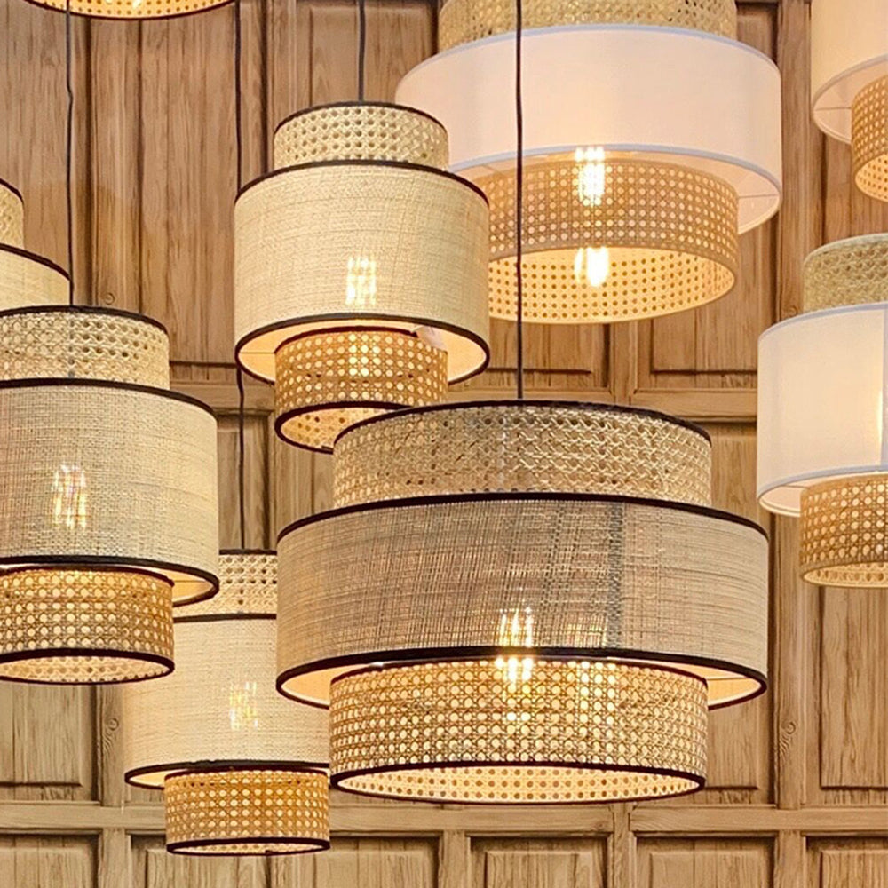 Several warm woven-shade pendants in a wood-paneled room