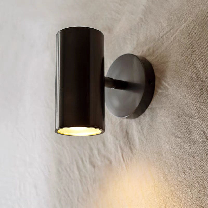 Black Freja cylinder in a vertical position casting warm light downward.