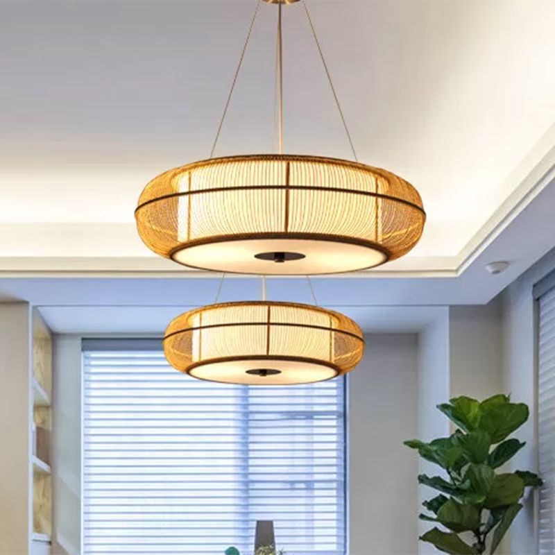 Two Ozawa wood-tone pendants pictured over a counter