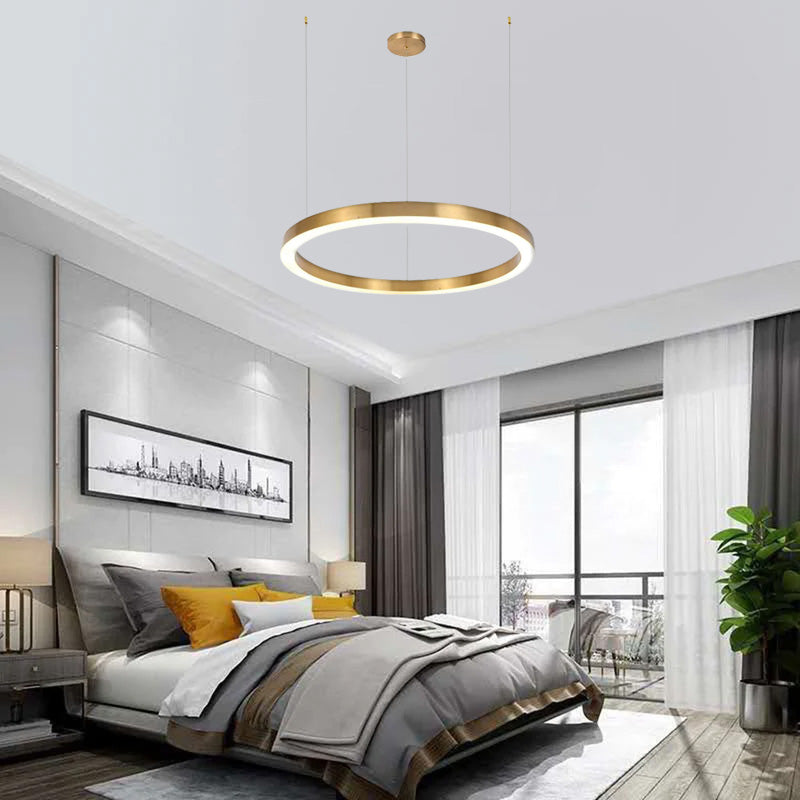 One gold-colour ring pendant above a bedroom bed