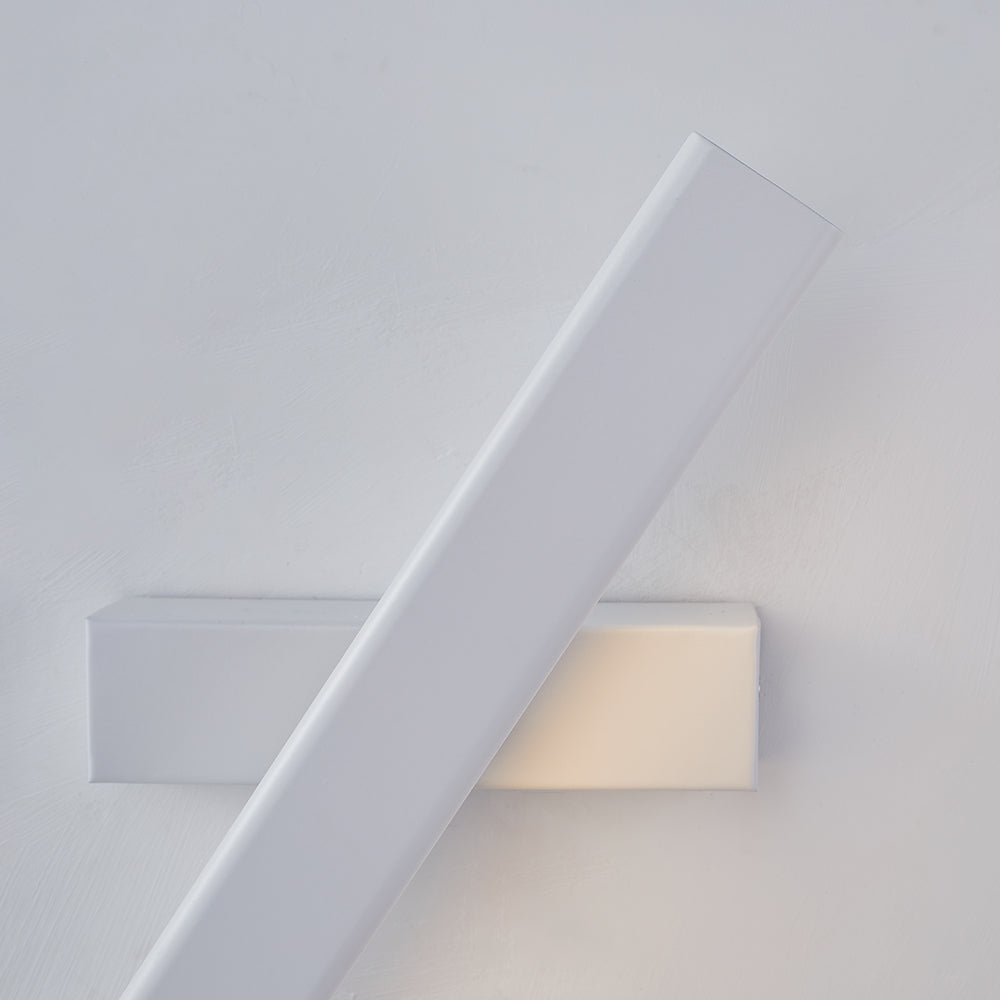 Close view of a steeply angled white Aqsa bar crossing a horizontal white base on a pale wall