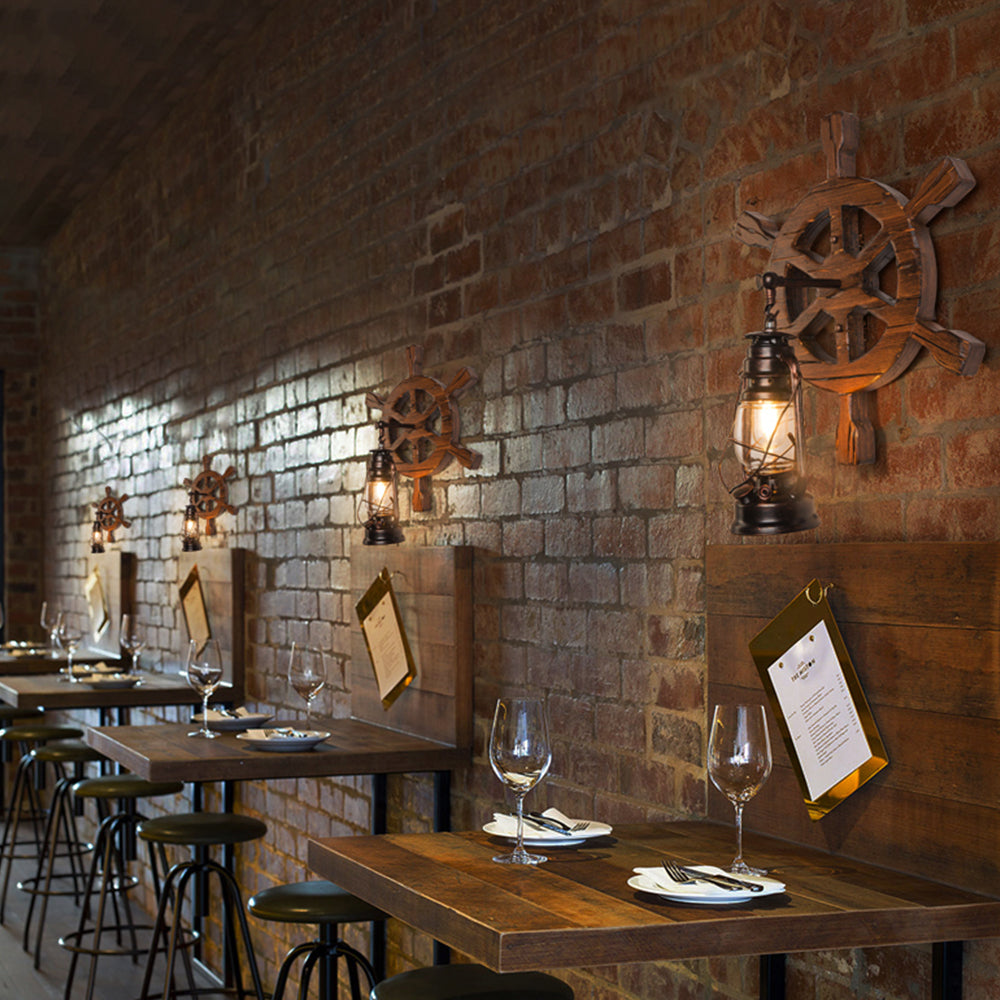 Several Austin ship-wheel lights along a brick restaurant wall