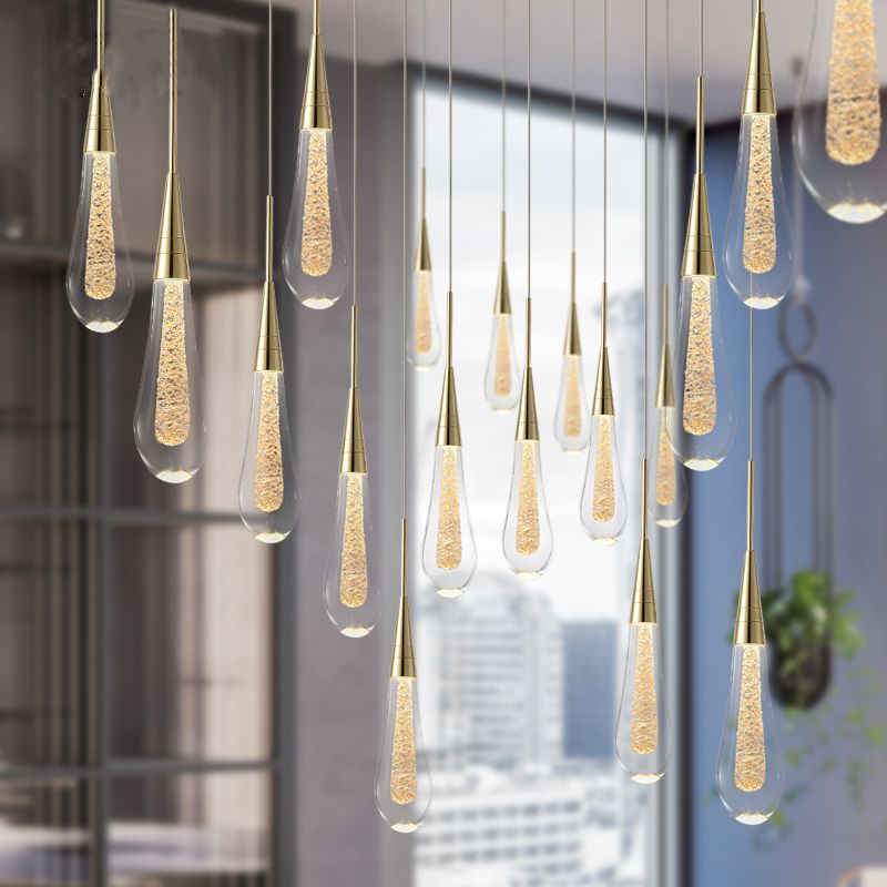 Multiple Hailie teardrop pendant groups at different heights beside a large interior window