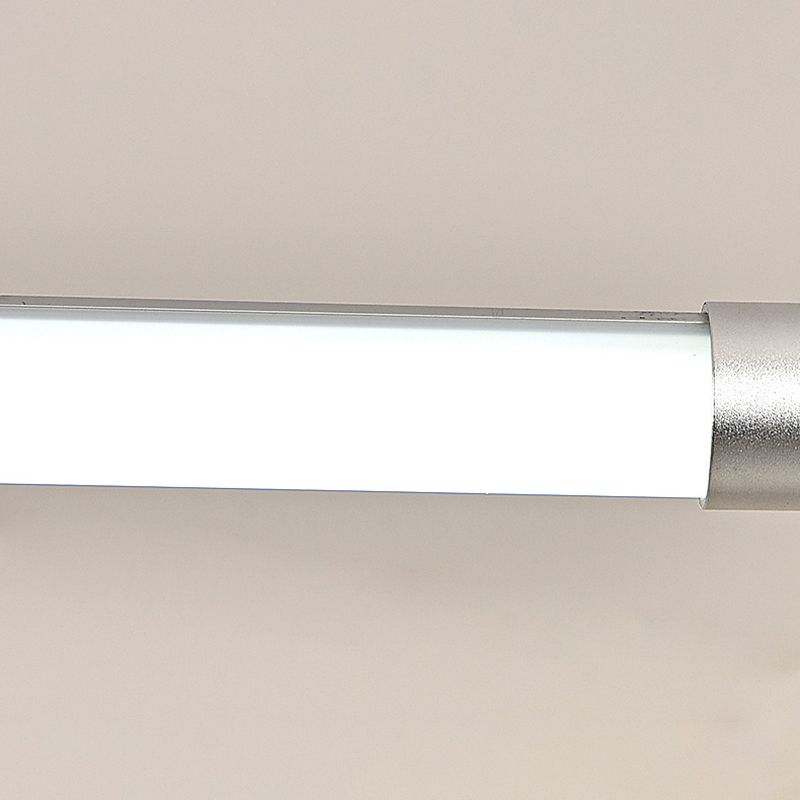 Close-up of the white luminous face, narrow metal rail and silver endcap of the linear pendant