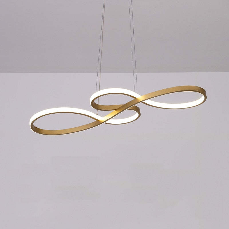 Gold curved loop pendant beneath a pale ceiling