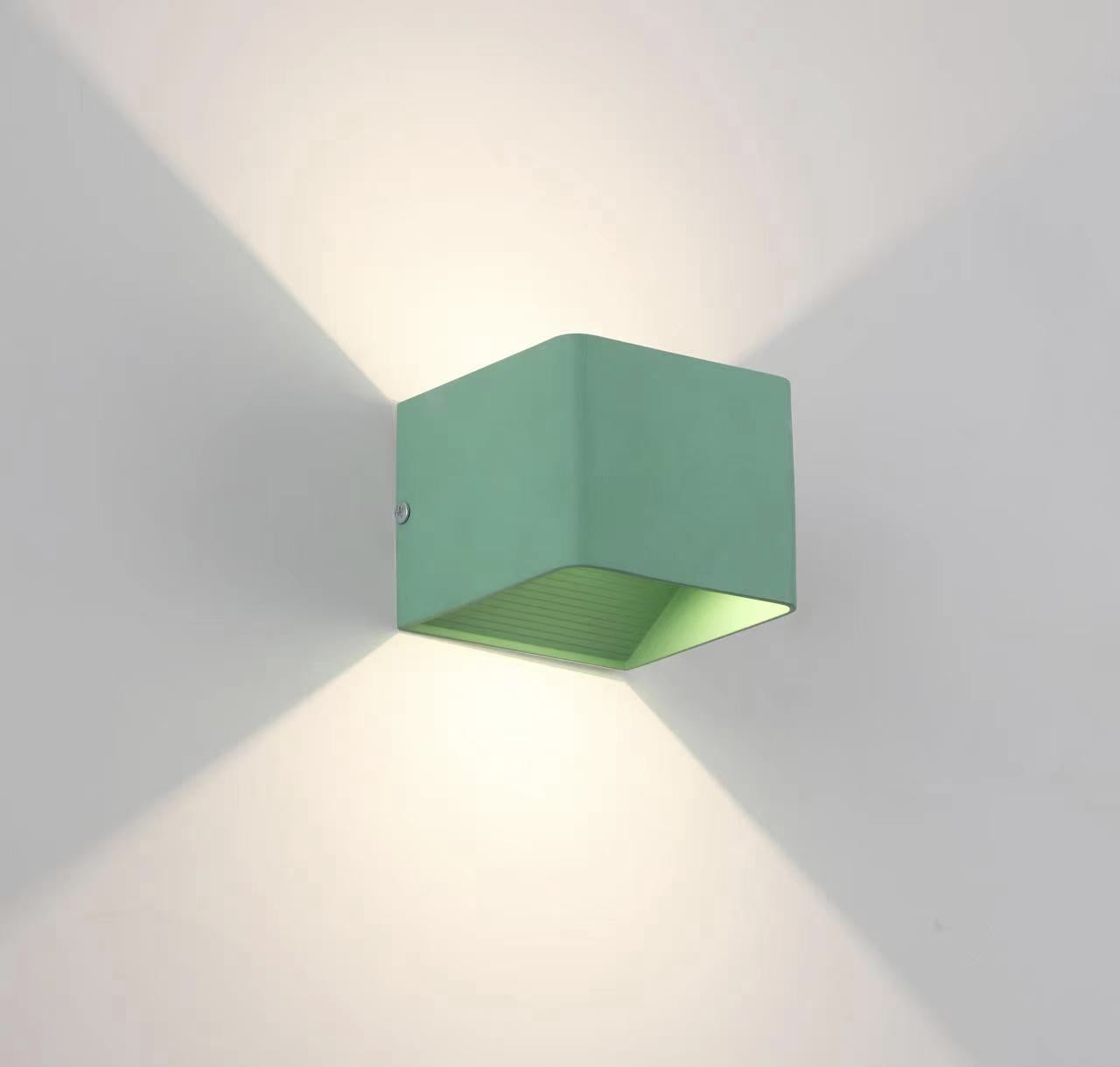 Green metal Orr wall lamp viewed at an angle