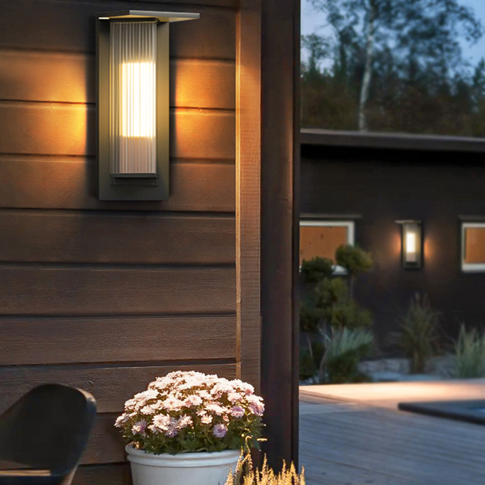 Lit Orr wall light on exterior timber siding at dusk