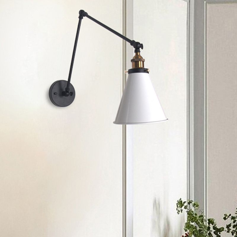 Brady White conical wall light with black articulated arm on a pale moulded wall near a plant