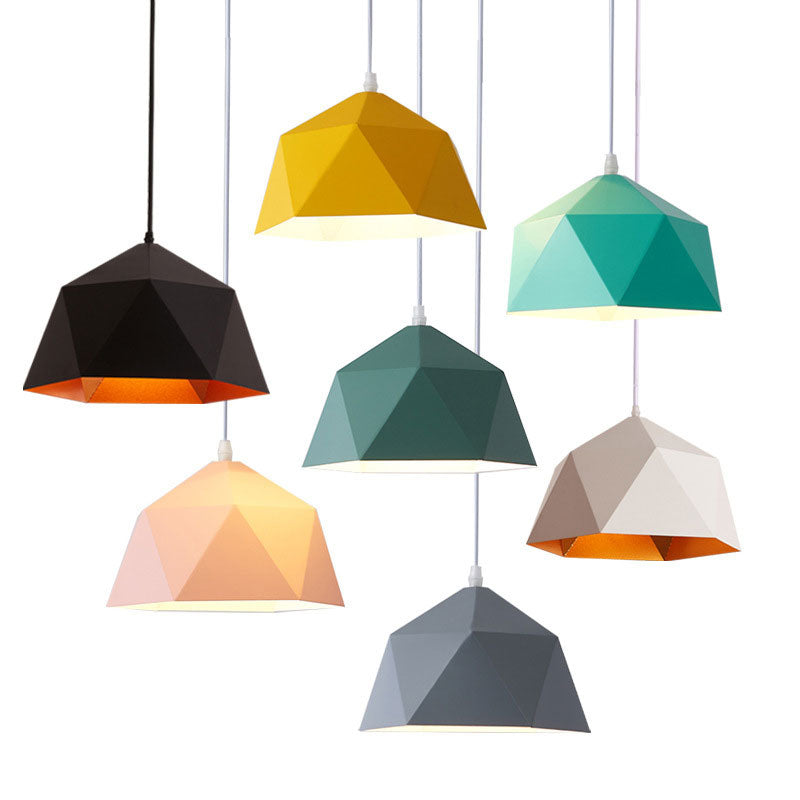 Mixed-color faceted pendant shades at staggered heights, showing contrasting open interiors