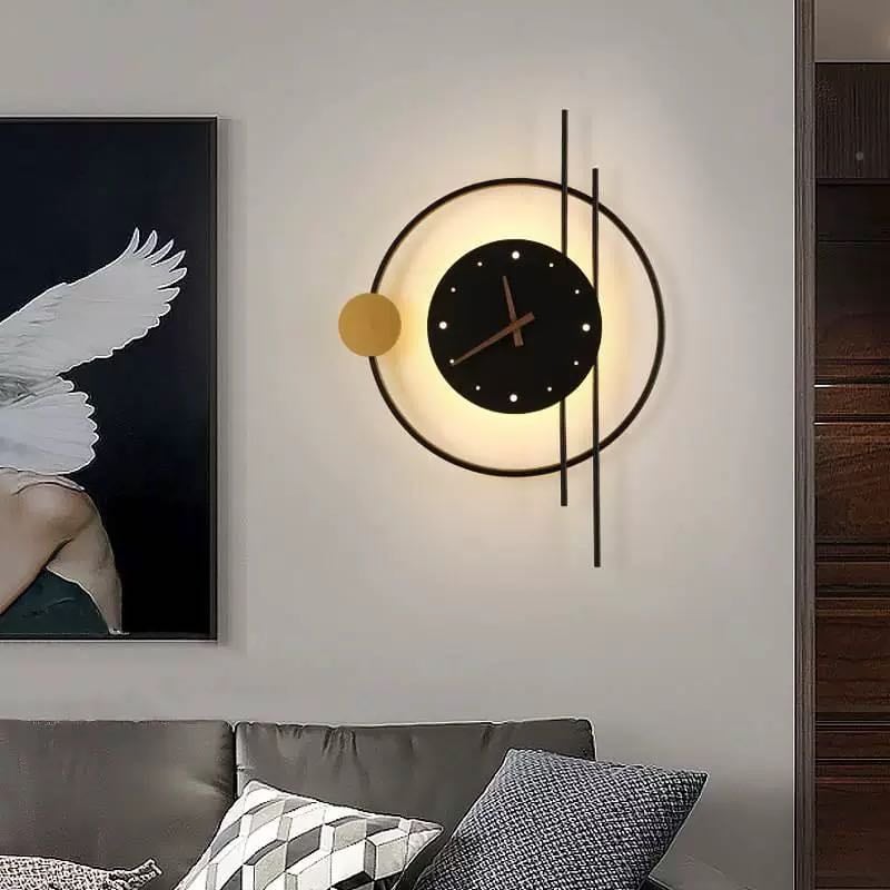 Black clock light with a gold accent disc above a sofa