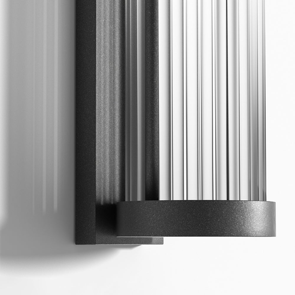 Ribbed transparent shade and black lower rim of the Orr wall lamp