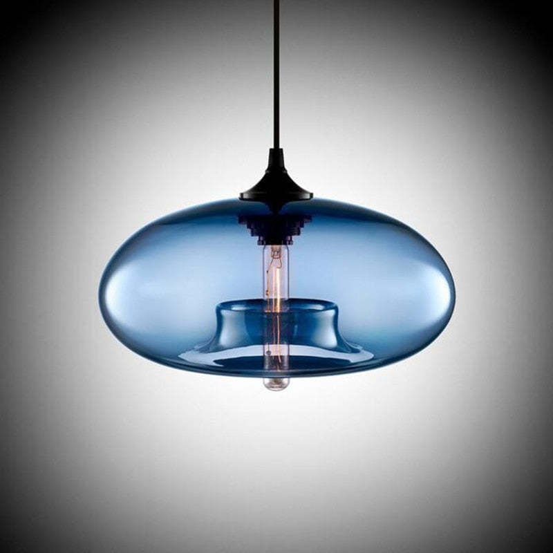 Blue flattened oval glass pendant shade with Black cap, cable and a central vertical bulb on a gradient background