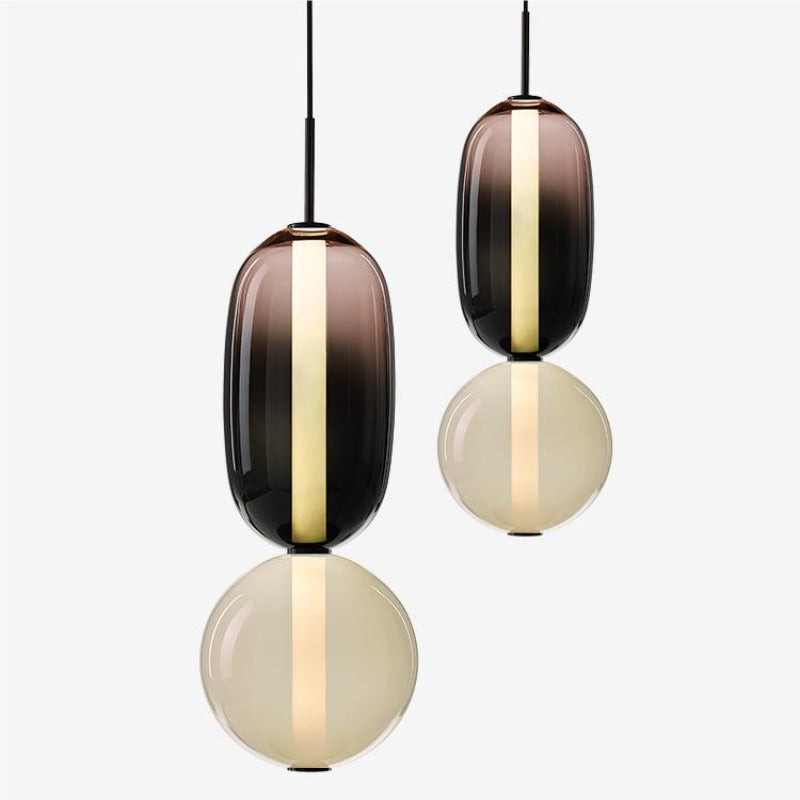 Two sizes of a smoked-capsule and pale-globe pendant shown side by side with black suspension stems