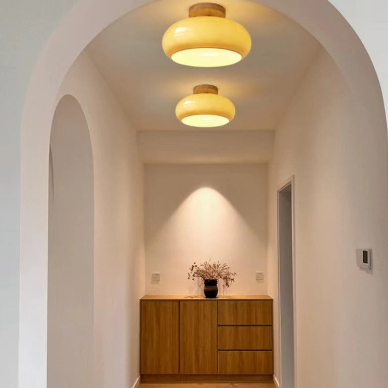Yellow dome ceiling lights under a hallway arch