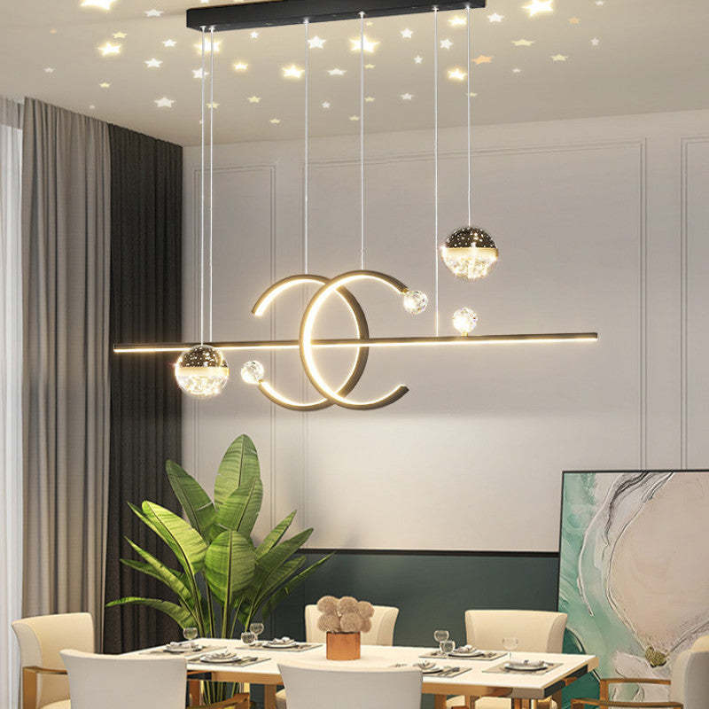 Madina pendant over a round dining table with ceiling stars pictured