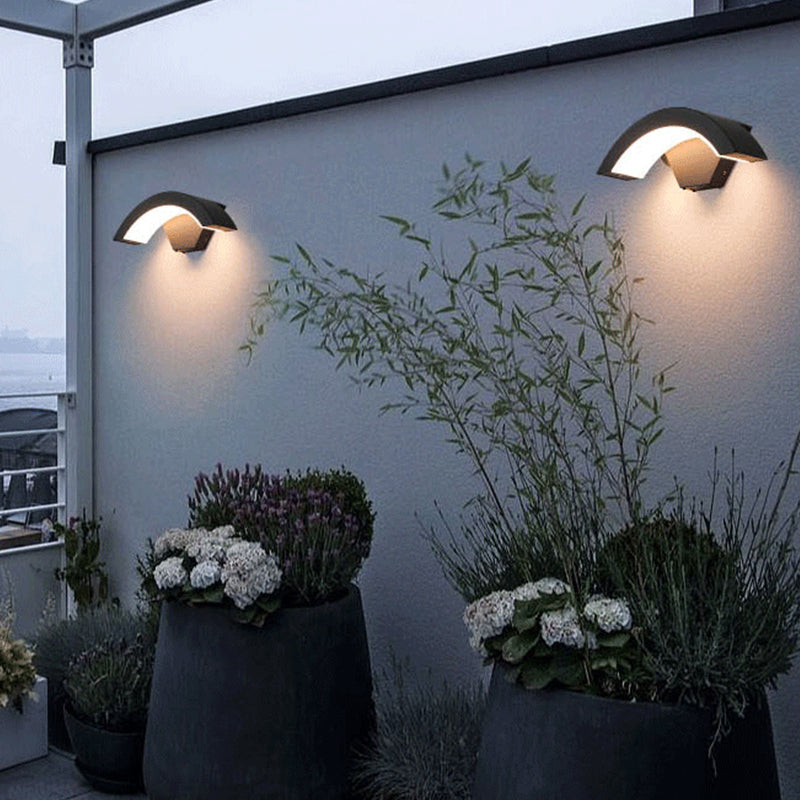 Steady Large arc wall lights above terrace planters