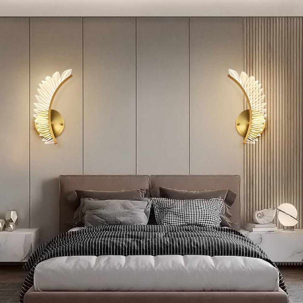 Mirrored Kristy single-wing wall lights on either side of a bedroom headboard
