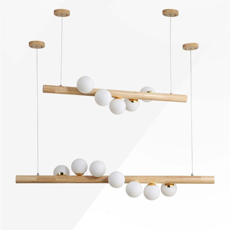 Separate five- and seven-globe light wood pendant examples with two ceiling canopies each on a White background